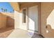 Inviting front entry with a welcoming mat and side window at 2915 Rippling Springs St, Laughlin, NV 89029