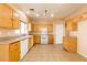 Well-equipped kitchen with light wood cabinets and white appliances at 2915 Rippling Springs St, Laughlin, NV 89029