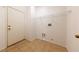 Bright laundry room with tile flooring, shelving and exterior access at 2915 Rippling Springs St, Laughlin, NV 89029