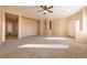 Bright living room with neutral carpet and ceiling fan at 2915 Rippling Springs St, Laughlin, NV 89029