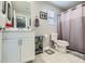 Clean bathroom with white vanity, gray shower curtain, and tiled floor at 3177 Bivona Walk, Henderson, NV 89044