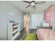 Bright bedroom with gray flooring, built-in shelving, and pink accents at 3177 Bivona Walk, Henderson, NV 89044