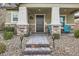 Inviting front porch with stone columns and blue chairs at 3177 Bivona Walk, Henderson, NV 89044