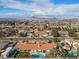 Beautiful aerial shot shows a neighborhood with mature trees, swimming pools, and city views at 321 E Middleton Dr, Henderson, NV 89015