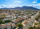 Bright aerial shot displays a residential neighborhood with lush landscaping and distant mountains at 321 E Middleton Dr, Henderson, NV 89015