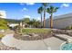 Expansive backyard showcasing desert-inspired landscaping, a shaded patio, and a glimpse of the nearby pool area at 321 E Middleton Dr, Henderson, NV 89015