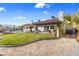 A lush backyard features desert landscaping, a glimpse of the pool, and a spacious patio for outdoor enjoyment at 321 E Middleton Dr, Henderson, NV 89015