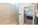Bright bathroom featuring a shower-tub combo with white tiles and modern fixtures at 321 E Middleton Dr, Henderson, NV 89015