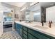 Well-lit bathroom boasts double sinks, a quartz countertop, and black-and-white patterned flooring at 321 E Middleton Dr, Henderson, NV 89015