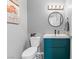 Stylish powder room showcasing a modern vanity, round mirror, and sleek fixtures, and decorative wall accents at 321 E Middleton Dr, Henderson, NV 89015