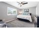 Comfortable bedroom with a modern ceiling fan, large window, and contemporary artwork at 321 E Middleton Dr, Henderson, NV 89015
