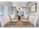 This dining room features modern chandelier, decor and lots of natural light at 321 E Middleton Dr, Henderson, NV 89015
