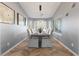 Elegant dining room with ample natural light, decorative light fixture and wood floors perfect for entertaining at 321 E Middleton Dr, Henderson, NV 89015