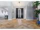 Home entryway with Herringbone floors, double door entrance, gray walls, and modern light fixture at 321 E Middleton Dr, Henderson, NV 89015