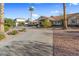Wide view of single story home with long driveway, desert landscaping, and terracotta tile roof on a clear day at 321 E Middleton Dr, Henderson, NV 89015