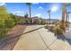 Front view of a single story home with a long driveway and desert landscaping on a sunny day at 321 E Middleton Dr, Henderson, NV 89015