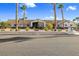 Single story home with a desert landscaped front yard with palm trees and a terracotta tile roof on a clear day at 321 E Middleton Dr, Henderson, NV 89015