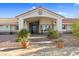 Front entrance to single-story home with double-door entry, portico, desert landscaping and rock facade at 321 E Middleton Dr, Henderson, NV 89015