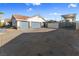 View of a home's two-car garage with RV parking and awning plus desert landscaping in the surrounding yard at 321 E Middleton Dr, Henderson, NV 89015