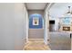 Hallway showcasing natural light leading to the open living area with a cozy fireplace at 321 E Middleton Dr, Henderson, NV 89015