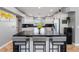 Kitchen island with a black countertop, white cabinets, and bar seating at 321 E Middleton Dr, Henderson, NV 89015