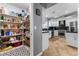 Bright kitchen features white cabinets, stainless steel appliances, and herringbone-patterned wood floors, plus a walk-in pantry at 321 E Middleton Dr, Henderson, NV 89015