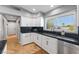 Bright kitchen with white cabinets, black countertops, and stainless steel appliances under natural light at 321 E Middleton Dr, Henderson, NV 89015