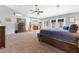 Spacious primary bedroom featuring a fireplace, ceiling fan, and access to backyard at 321 E Middleton Dr, Henderson, NV 89015