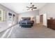 Spacious primary bedroom featuring neutral colors, ceiling fan, and access to backyard at 321 E Middleton Dr, Henderson, NV 89015