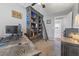 This home office features custom dark wood bookcase with ladder, comfortable workspace and natural light at 321 E Middleton Dr, Henderson, NV 89015