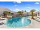 Beautifully landscaped pool with waterfall and lush tropical palms, offering a tranquil retreat for leisure and relaxation at 321 E Middleton Dr, Henderson, NV 89015