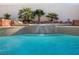 Pool with a waterfall feature cascading over decorative tiles, enhanced by lush tropical landscaping, and serene spa features at 321 E Middleton Dr, Henderson, NV 89015