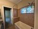 Tiled bathroom featuring a bathtub with shower, granite counter tops, and a decorative window at 3550 Bay Sands Dr # 3081, Laughlin, NV 89029