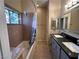 Bathroom featuring double sinks, granite counters, tub shower, and decorative glass window at 3550 Bay Sands Dr # 3081, Laughlin, NV 89029