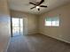 Carpeted bedroom featuring a ceiling fan, window with blinds, and balcony access at 3550 Bay Sands Dr # 3081, Laughlin, NV 89029