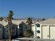 Apartment complex featuring mountain views, palm trees, and covered parking at 3550 Bay Sands Dr # 3081, Laughlin, NV 89029