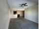 Open living area with a ceiling fan, carpet flooring, and adjoined kitchen space at 3550 Bay Sands Dr # 3081, Laughlin, NV 89029