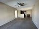 Open-concept living room with neutral carpeting and ceiling fan flows into the kitchen at 3550 Bay Sands Dr # 3081, Laughlin, NV 89029