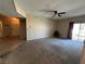 A carpeted living room with a sliding glass door to a balcony and view to the entryway at 3550 Bay Sands Dr # 3081, Laughlin, NV 89029