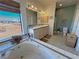 Relaxing bathroom with a jacuzzi tub, a double sink vanity, and beautiful views of the surrounding landscape at 3821 S Tumbleweed Ave, Pahrump, NV 89048