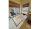 Bright bathroom with a jacuzzi tub, tile flooring, and a large window offering scenic outdoor views at 3821 S Tumbleweed Ave, Pahrump, NV 89048