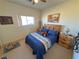 Neutral bedroom featuring a bed with blue bedding, wood furniture, and a window at 3821 S Tumbleweed Ave, Pahrump, NV 89048