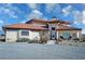 Single-story home with red tile roof, large windows, and landscaped yard at 3821 S Tumbleweed Ave, Pahrump, NV 89048