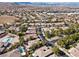 An elevated aerial view of a sprawling suburban community with mature landscaping and beautiful mountain views at 4493 Rometta Ave, Las Vegas, NV 89141