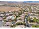 A high-angle aerial view of a desert community with mature landscaping and community pools at 4493 Rometta Ave, Las Vegas, NV 89141