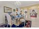 Chic dining room features glass table, elegant chairs, and stunning chandelier at 4493 Rometta Ave, Las Vegas, NV 89141