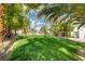 Lush green grassy area with palm trees in a community setting at 5040 Sublight Ave, Las Vegas, NV 89108