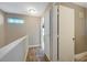 Upstairs hallway with carpet and doors to bedrooms and bathroom at 5040 Sublight Ave, Las Vegas, NV 89108