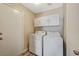 Laundry room with washer, dryer, and overhead cabinets at 5040 Sublight Ave, Las Vegas, NV 89108