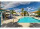 Community pool with a blue tile finish, picnic tables, and palm trees at 5040 Sublight Ave, Las Vegas, NV 89108